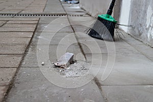 City street sidewalk cleaning from trash by broom