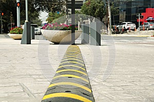 City street with striped plastic speed bump