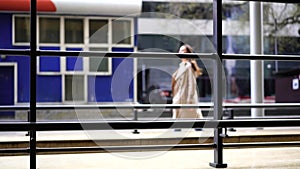 City street with walking woman at spring or fall day