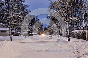 City street in winter, snow-covered trees, Joensuu, Finland photo