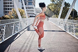 City, stretching legs and body of woman in fitness exercise, runner workout or training in sports fashion on bridge