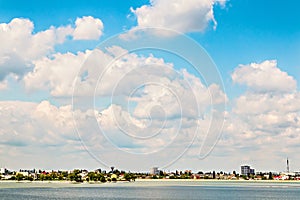 City summer landscape near lake cloudy sky