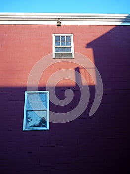 City: sunset building shadow on red wall