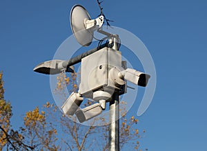 A city surveillance camera against a blue sky.