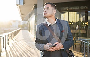 City, thinking or business man with phone for internet research, communication or networking. Tech, online or