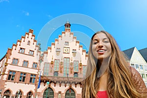 City tourism lifestyle in Germany. Young woman visiting Frankfurt old town. Smiling tourist woman in Romerberg square, Frankfurt,