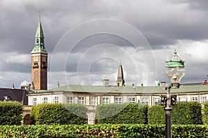 City towers in central Copenhagen against the rainy cloudy sky.