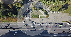 City traffic cars top view on the big city road. Cars drive through the city on a busy highway among high-rise buildings