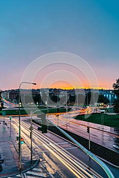 City traffic lights in rainy evening,Prague,Czech republic.Long exposure lights.Movement of cars at colorful sunset.Night town