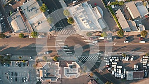 City traffic at sunset. Busy street in the city center. Cars cross the intersection. The camera looks down from a bird's