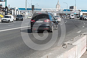 City trafic on the road. Black minivan Ford Galaxy Second generation car drives on Moscow streets. Side rear view of a minivan