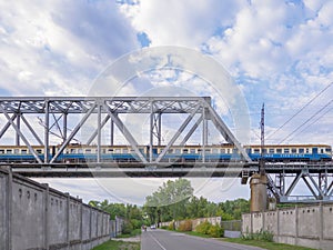 City urban train moving along the railroad bridge in Kyiv