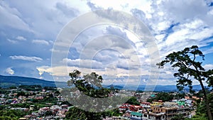 City urbanization view with mountain range at background at morning from flat angle