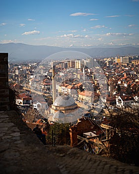 a city view with an aerial view of buildings and an old clock tower