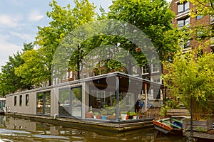 City view of Amsterdam canal and houseboat, Holland, Netherlands