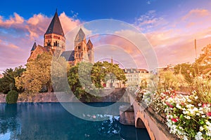 city view of an ancient Neuf Church on the bank of the Moselle river in Metz in France during the sunrise. Tourist