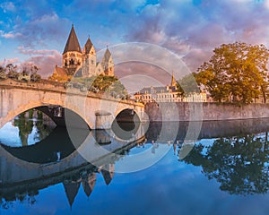 City view of an ancient Neuf Church on the bank of the Moselle river in Metz in France during the sunrise. Tourist