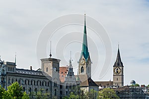 City view of old downtown at the bank of Limmat River of Zurich city, with beautiful house, and Church of  Fraumunster