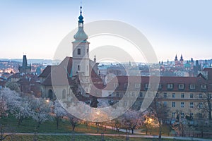 City view of Prague old town, Czech Republic. Red roof tops in the horizon. Church of Our Lady Victorious and The Infant Jesus