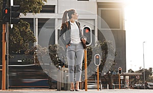 City, walking and woman on a crosswalk wait with travel, business commute and urban journey. Road, outdoor and female