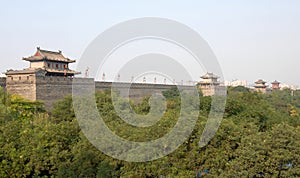 City Wall, Xian, Shaanxi Province, China. Watchtowers on Xian city wall overlooking trees.