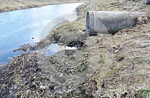 City water gushing from the sewer. Water pollution.