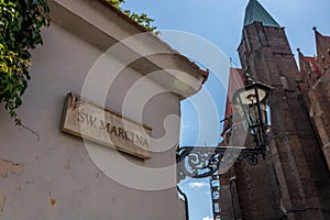 City Wroclav street sign table with lamp and church behind