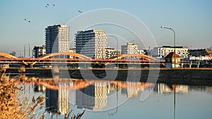 The city of Wroclaw, the Trzebnica bridge over the Odra river, construction of new apartments