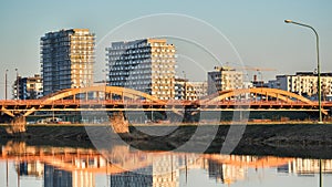 The city of Wroclaw, the Trzebnica bridge over the Odra river, construction of new apartments