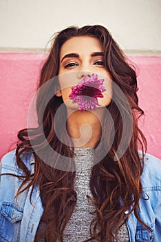 In the city you have to be strong and fragile. Portrait of a beautiful young woman posing against a wall outside.