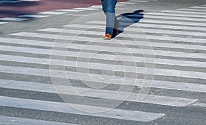 City zebra crossing with one walking pedestrian