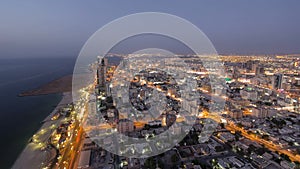 Cityscape of Ajman from rooftop day to night aerial timelapse photo