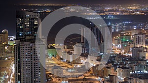 Cityscape of Ajman from rooftop night aerial timelapse