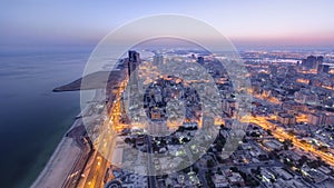 Cityscape of Ajman from rooftop night to day timelapse. Ajman is the capital of the emirate of Ajman in the United Arab Emirates. photo