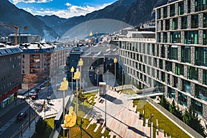 Cityscape of Andorra la Vella capita city of Andorra wit men sitting on poles