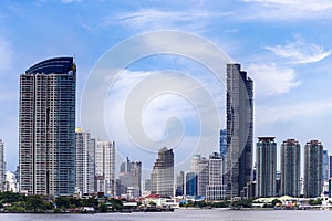 Cityscape of Bangkok city skyline with river and blue sky background, Bangkok city is modern metropolis of Thailand and favorite