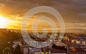 The cityscape of beautiful Florence, Italy, as the cloudy sky erupts with color as the sun sets