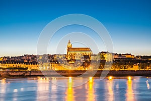 Cityscape of Blois with Cathedral over Loire river France at dusk