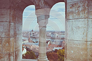 Cityscape of Budapest, Hungary photographed through the arch window of the Fishermans Bastion. Hungarian Parliament Building,