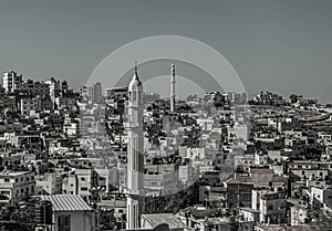 The cityscape, buildings, roofs, and mosque minarets, at Ramallah.