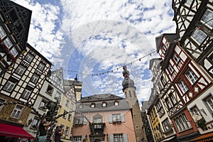 Cityscape of Cochem with its typical half-timbered houses and restaurants. Market square with town hall in background and music ba