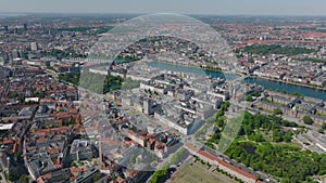 Cityscape with curving line of lakes around city centre. Aerial view of metropolis from height. Copenhagen, Denmark