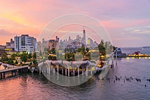 Cityscape of downtown Manhattan skyline with the Little Island Public Park in New York City at sunrise