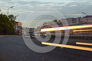 Cityscape at dusk with the city traffic at foreground