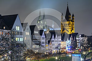 Cityscape - evening view on the Rhine promenade on background the Great Saint Martin Church and Cologne Cathedral