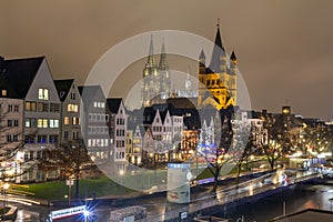 Cityscape - evening view on the Rhine promenade on background the Great Saint Martin Church and Cologne Cathedral