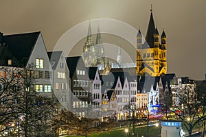 Cityscape - evening view on the Rhine promenade on background the Great Saint Martin Church and Cologne Cathedral