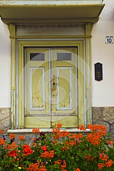 Cityscape of FaÃ§ade and door with flowers, in Cortina dAmpezzo, Province of Belluno, Italy photo