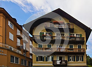 Cityscape of FaÃ§ade and flowers on balconies, in Cortina dAmpezzo, Province of Belluno, Italy photo