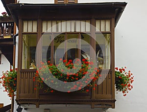 Cityscape of FaÃ§ade and flowers on balcony, in Cortina dAmpezzo, Province of Belluno, Italy photo